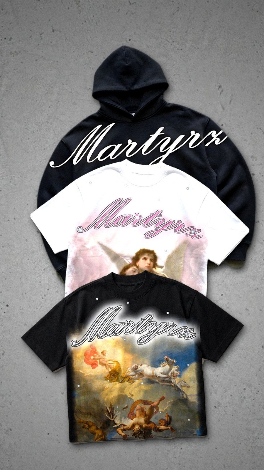 Hoodie and tees fanned out on concrete